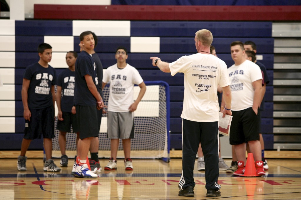 Gym teacher instructing students in the Syracuse Academy of Science Charter School. Michael Davis Photo | Syracuse New Times