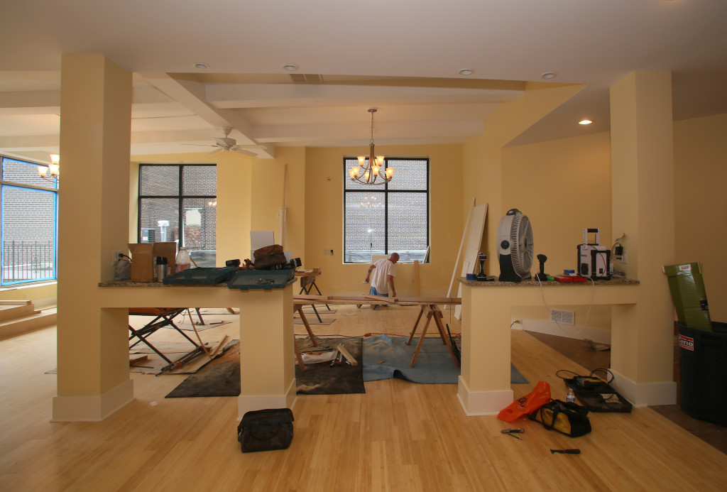 Painter Brian Thompson does touch-up work in the living room at 443 S. Warren St.