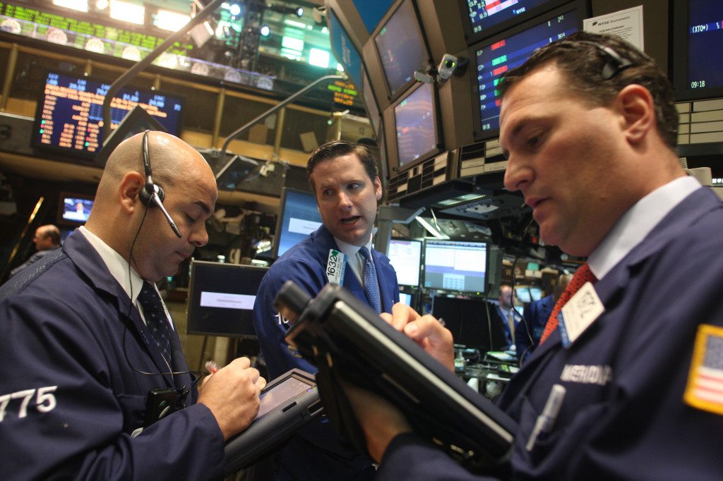 Stock Traders work on the floor of the New York Stock Exchange before the opening bell.    (Hiroko Masuike for The New York Times)