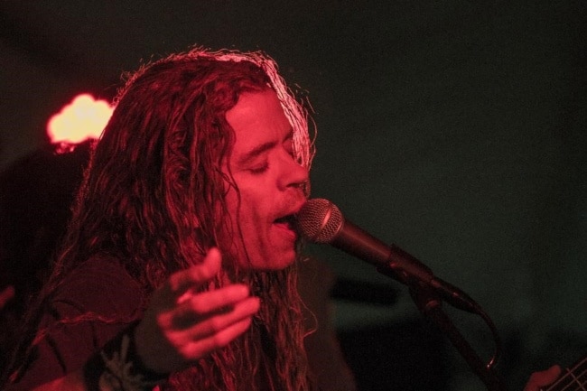 A backing vocalist for Under the Gun at Wing Fest 2018