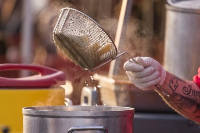 A basket of wings is tossed in breadcrumbs at Wing Fest 2018