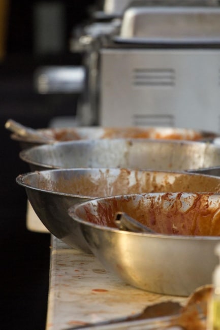 A close up shot of big tin bowls used to coat wings in hot sauce at Wing Fest 2018